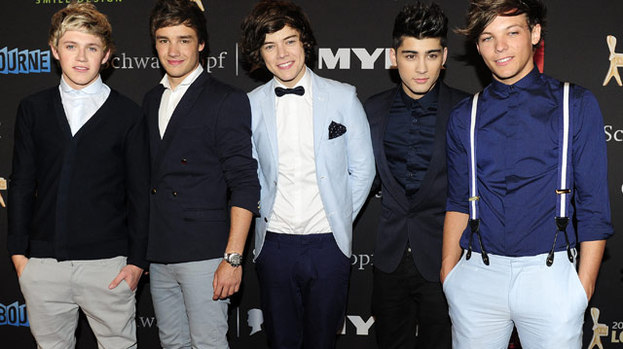 Strumming their way to the top: The One Direction boys were given guitars worth £20,000