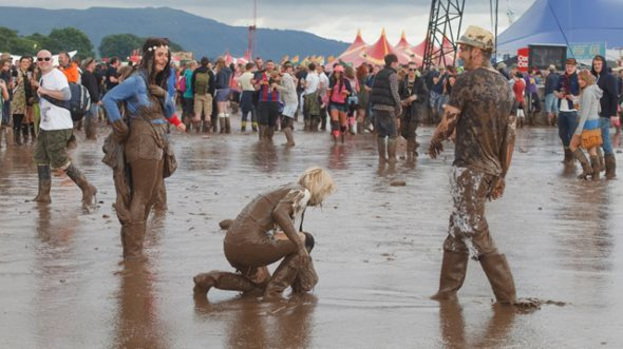 Mud bath: But T in the Park fans didn't let a bit of rain and mud put them off their stride