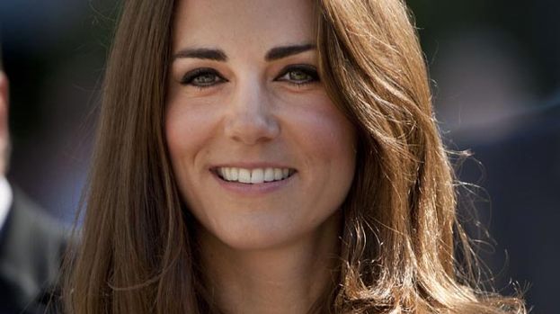 Pretty as a princess: Duchess Kate turned heads at the press reception last night