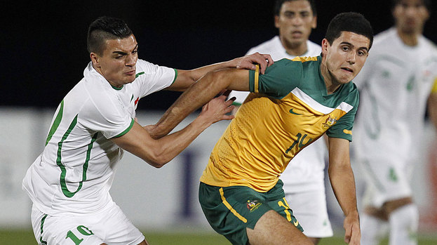 Australia's Tom Rogic fends off Iraq's Yaseen during their Olympic Games AFC Asian qualifying match in Gosford