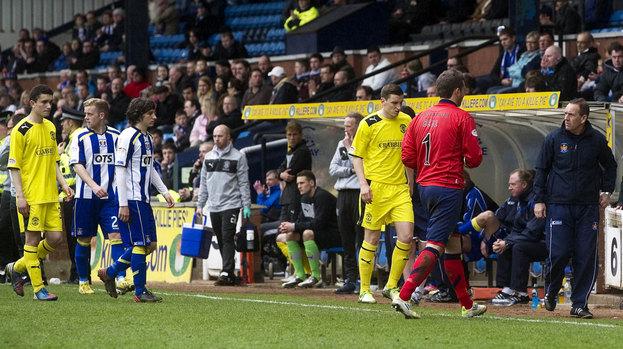 Both sets of players make their way off the park after a fan fell ill in the stand