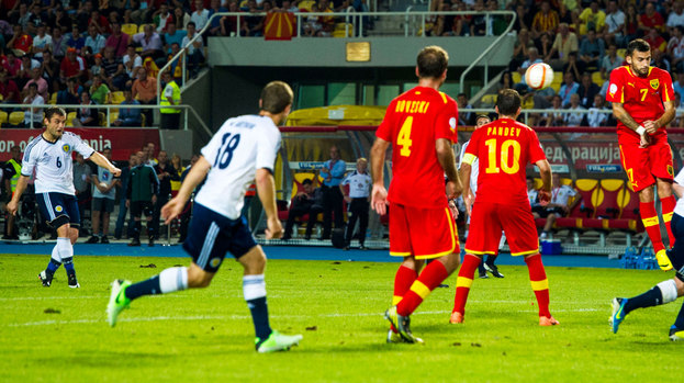 Scotland's Shaun Maloney (left) scores the winning goal of the game with a stunning free-kick