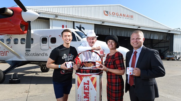 Picture shows (L-R): Sean Batty with Fergus Loudon, operations director at Tunnock's, Tricia Thistle, lead instructor in cabin safety at Loganair and Jonathan Hinkles, managing director at Loganair.